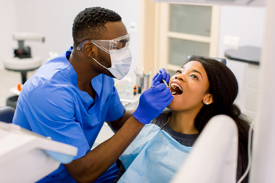 Photo of dental expert cleaning teeth.