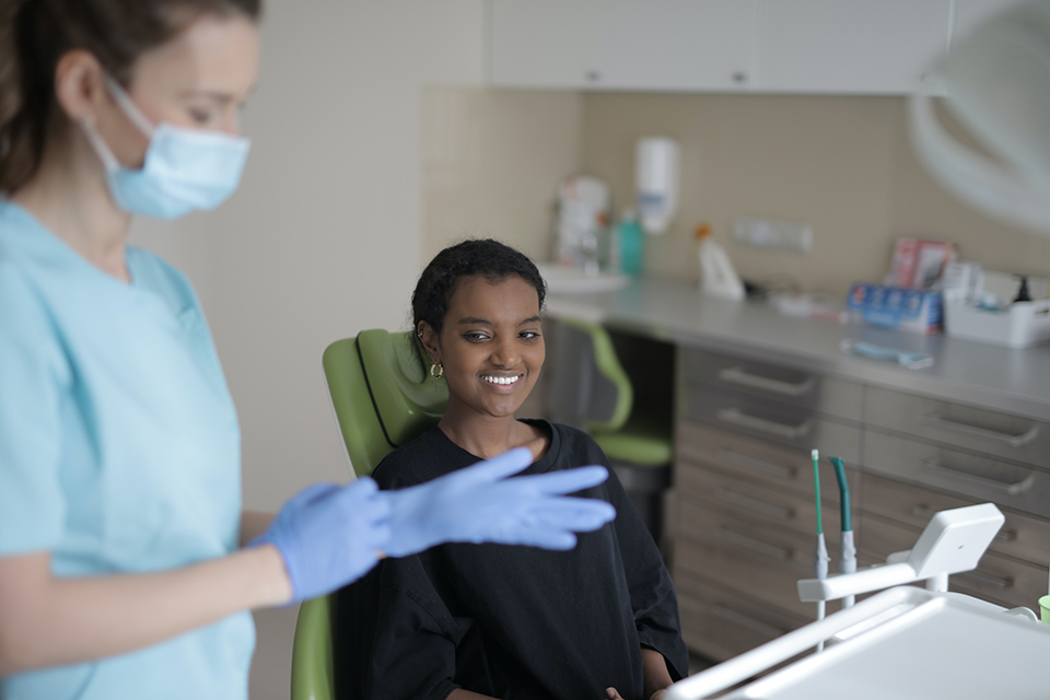 Patient sits in dental chair during appointment